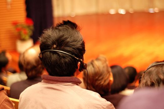 The audience wearing head phone for online translation