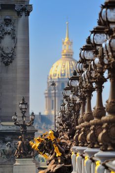 Lampposts on the bridge and the golden Dome of the Cathedral