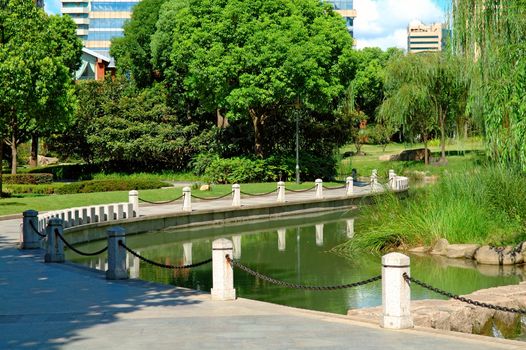 The view of walkway beside a pond in park