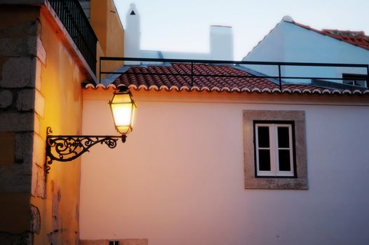 The antique lantern (street lamp) hanging on the (exterior) wall of residential house