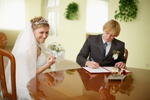 Solemn registration - the wedding ceremony. The bride and groom at the table