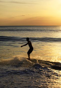 Young men - the surfer in ocean. Bali. Indonesia
