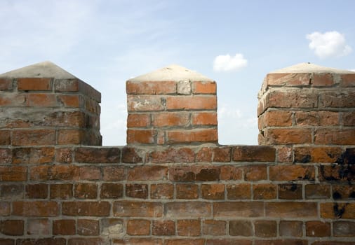 Photo of an ancient fence from a red brick