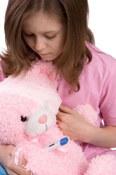 The girl embraces and kisses a toy-bear