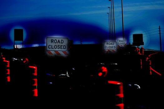 Road Closed Abstract is a representation of construction barriers on a highway offramp depecicted at night with the signs and barrel glowing creating a sense of danger during a dusky evening
