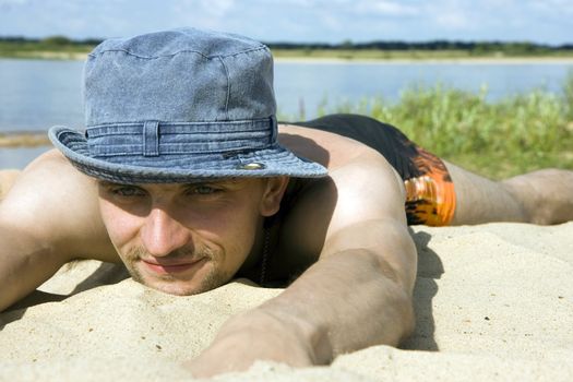 Photo of the man lying on a beach