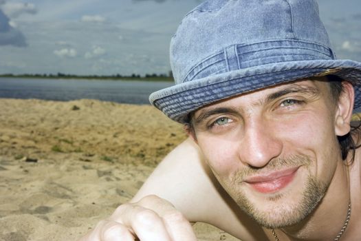 Photo of the man lying on a beach