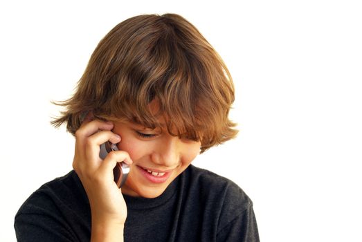 Smiling teenage boy talking on mobile phone isolated on white background.