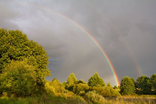 double rainbow in sky after summer rain