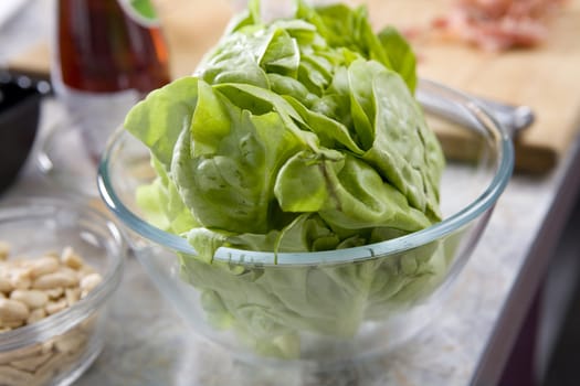 Green salad in a bowl on table before cooking