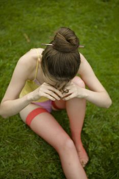 crying girl sitting on the grass. Teen`s problem. First love