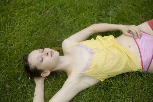 Young woman  sleeping  in summer park