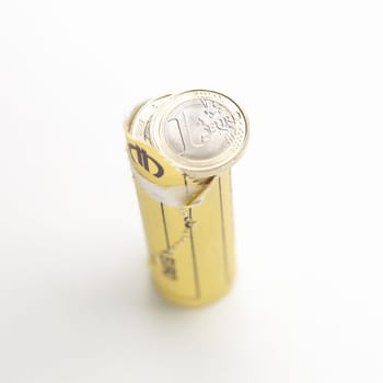 Opened roll of euro coins on white