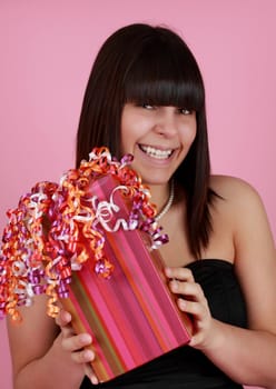 cute girl holding a nice wrapped gift box