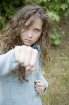 Portrait of an attractive young aggressive female punching