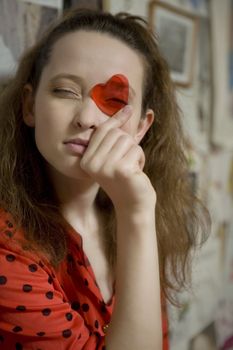 portrait of young attractive girl looking through the heart