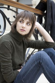 young attractive woman sitting at railing in state department store. Moscow