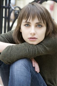portrait of young serious attractive woman with blue eyes