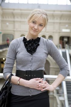 young attractive woman with bag standing at railing in state department store. Moscow