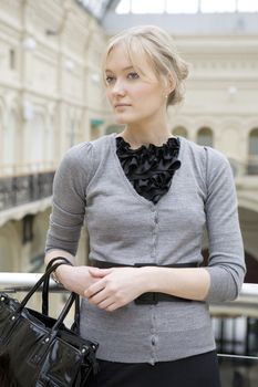 young attractive woman standing at railing in state department store. Moscow