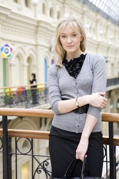 young attractive woman standing at railing in state department store. Moscow