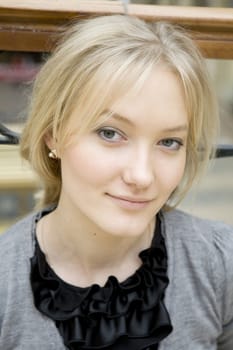 portrait of young serious attractive tired blond woman with blue eyes