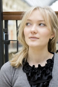 portrait of young serious attractive tired blond woman with blue eyes