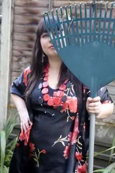 Gardener relaxing holding a rake