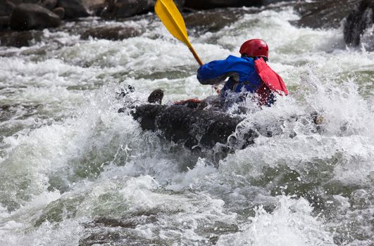 Canoeing in white water in rapids on river