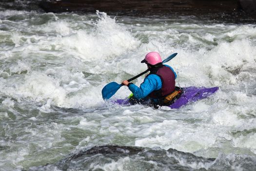 Canoeing in white water in rapids on river