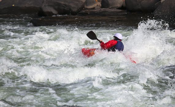 Canoeing in white water in rapids on river