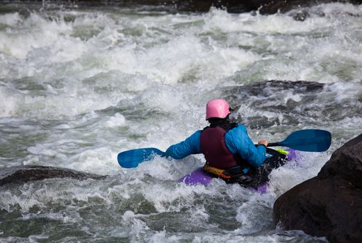 Canoeing in white water in rapids on river