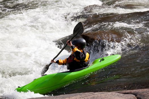 Canoeing in white water in rapids on river