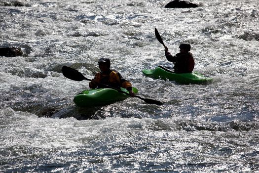 Canoeing in white water in rapids on river