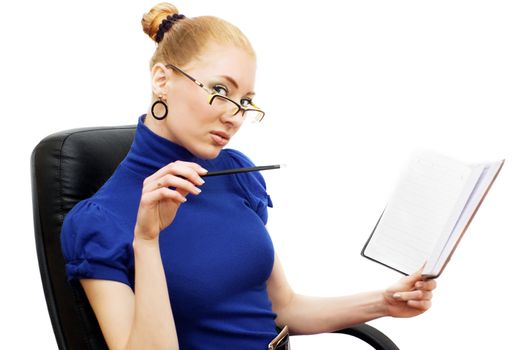 Attractive businesswoman in chair looking through glasses