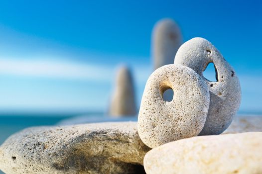 Two cobblestones with natural holes are on the rock