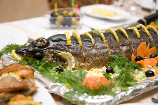 The served smoked fish on a celebratory table