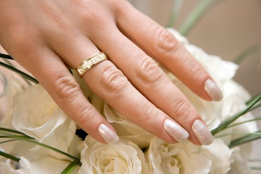 Photo of a wedding ring with jewels on a hand of the bride