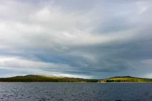 Island photo in northern sea under the cloudy sky