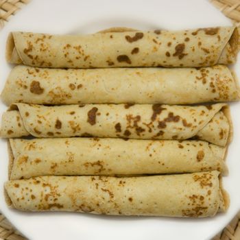 The braided pancakes on a white plate