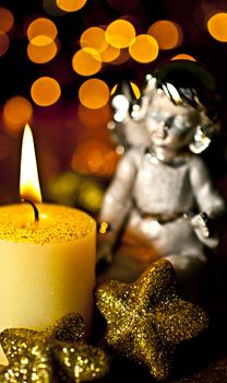 Christmas Angel staring at a burning candle. Rear Bokeh plan created by the filter, not  Photoshop.