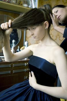 smiley hairdresser doing hairstyle attractive made of honour. 