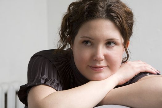 Young attractive smiling woman put head on hand