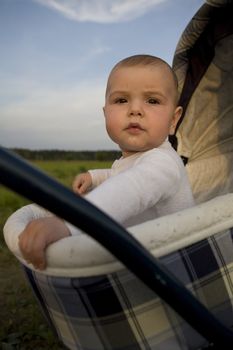 Baby in buggy. Summer time. Outdoor
