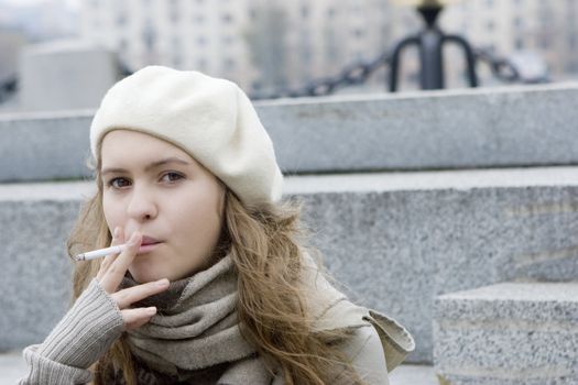 young teen girl sitting on the jaggies and smoking