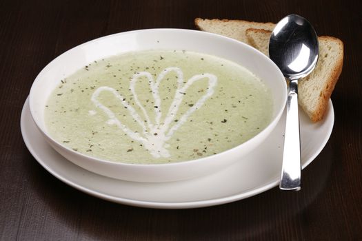 bowl of brocolli soup on table with clipping path