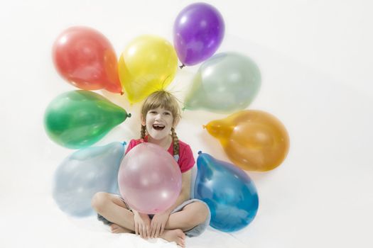 little happy giggle girl sitting with colour balloons. Girl celebrated her birthday. Isolated