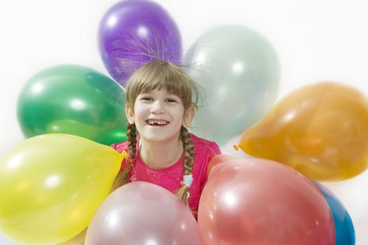 little happy giggle girl sitting with colour balloons. Girl celebrated her birthday. Isolated