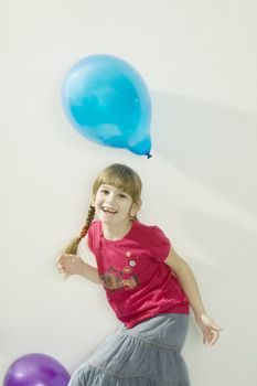 little happy giggle girl  playing with colour balloons. Girl celebrates her birthday. Isolated