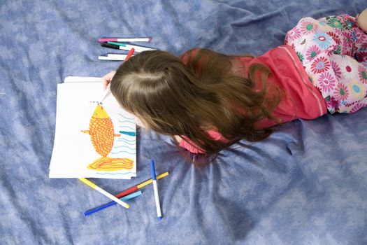 little cute smiling girl seven years old with drawing picture